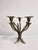 A fine, chiseled, three-flame candlestick in the style of French Art Deco.