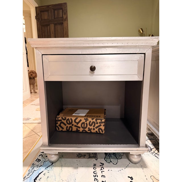 Features a brushed surface and exposed nailheads Crafted of wood and hand-wrapped in zinc-finished metal Mortise-and-tenon...