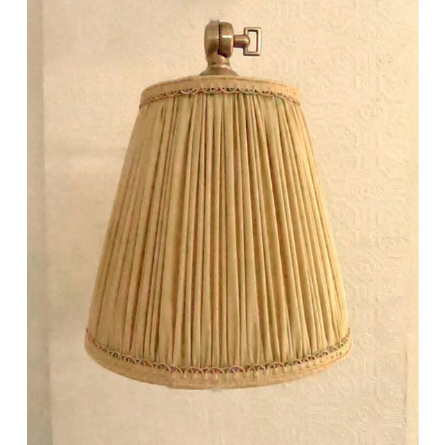Wall light is adjusted with three "keys". The fixture is solid brass with a light antique finish and holds a 60-watt max....