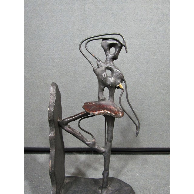 A striking vintage metal bookend featuring an abstract ballerina or dancer rendered in an expressive Brutalist / Modernist...