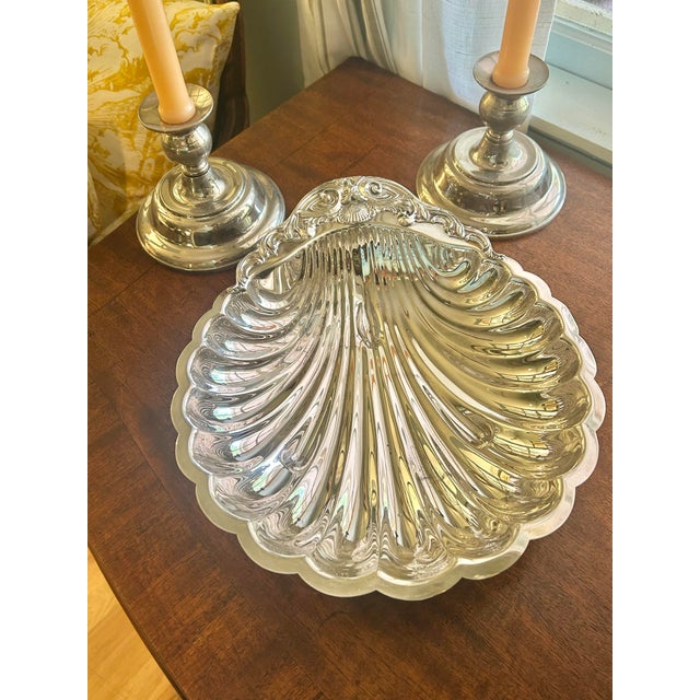This silver plate shell shaped dish has an image of Neptune in a very Rococo styled crest with shell and wave motifs. Most...