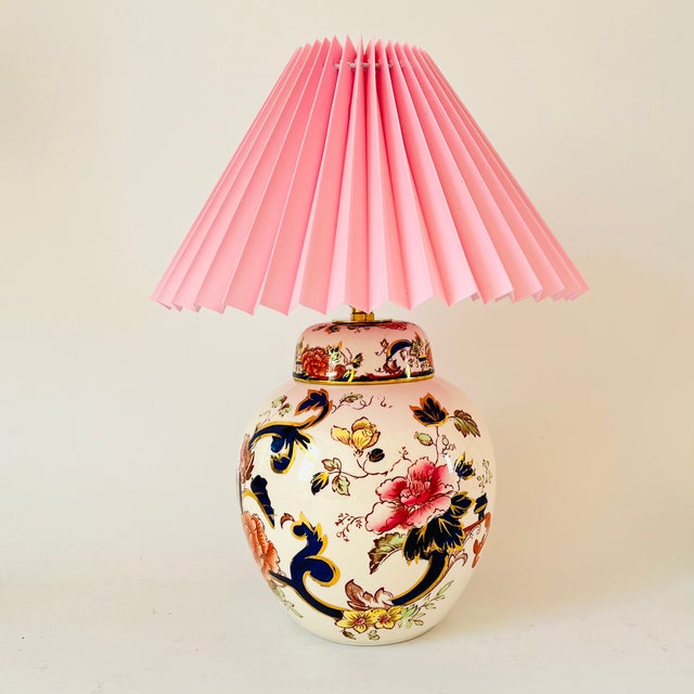A pair of mid 20th century round table lamps made from highly detailed ironstone mason’s jars. Decorated on an off white...