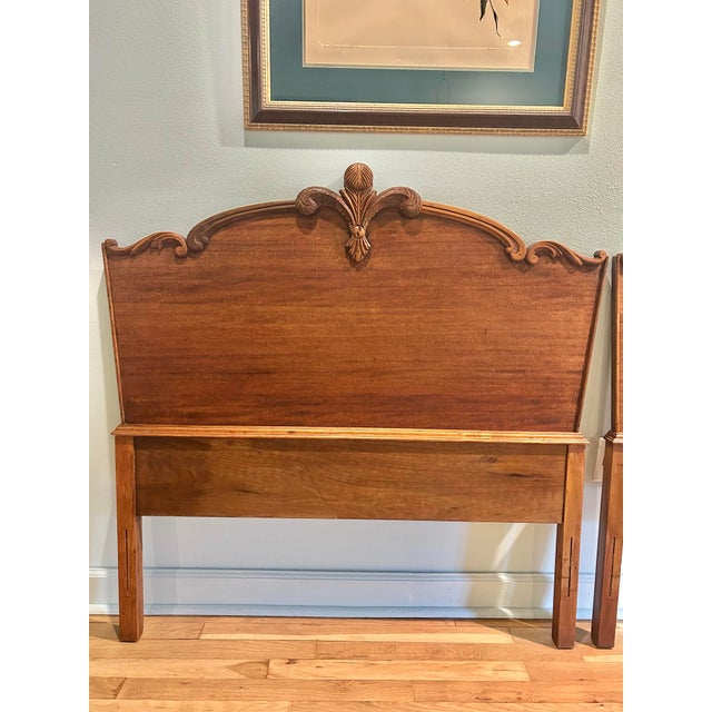 A matched pair of French Provincial twin headboards, showcasing the timeless elegance of Louis XV–inspired design. Crafted...