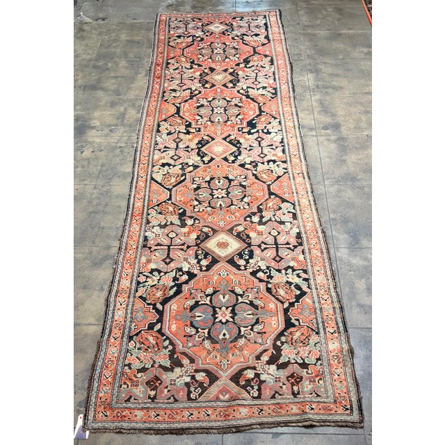 A richly patterned antique Karabagh runner, this substantial 16-foot-long carpet combines the strong geometry of Caucasian...