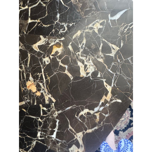 Elevate your space with this exquisite Empire Revival center table, masterfully crafted with a richly veined dark marble...