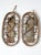 Pair of vintage 1940s snowshoes featuring a classic bear claw–shaped wood frame with hand-laced rope webbing and canvas...