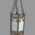 Antique bronzed metal Gothic style hanging ceiling fixture with white glass panels seated within its bronze colored metal...