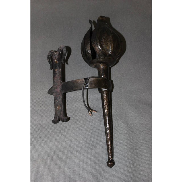 Pair of medieval-style wrought iron wall sconces signed Reboulet, wiring in good condition, 20th century, set in very good...