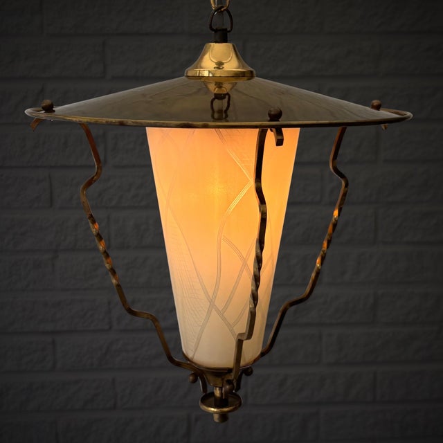 A mid-century modernist pendant lamp produced by an unidentified Swedish manufacturer in the 1950s. This elegant design...