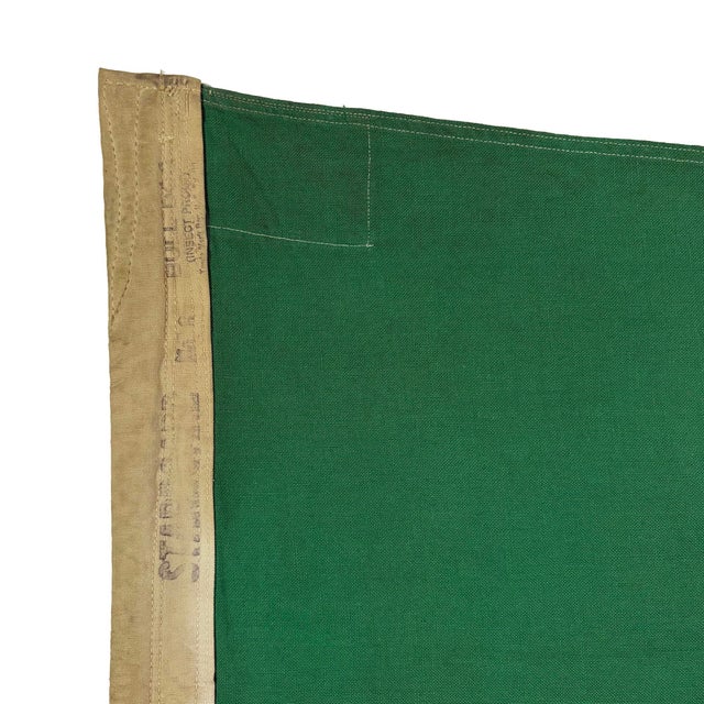 This vintage nautical flag is fully sewn from a cotton cloth, with overall staining and other wear from life at sea. Flag...