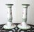 A pair of ceramic, polychrome, taper candle holders. Featuring a delicate handpainted floral pattern on white with a...