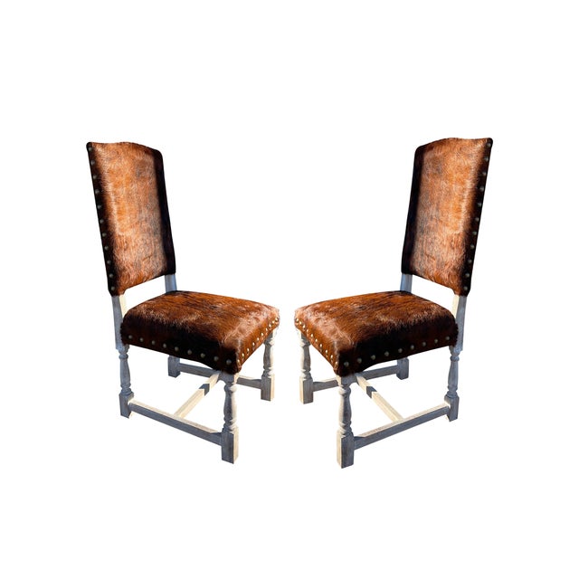 This set of four Southwestern rustic accent dining chairs features hair-on-hide genuine leather upholstery and a high back...