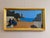 SEASIDE CONVERSATION Size: 11.8 x 21.5 inches (including frame) Oil on board A beautifully pared-back mid-century coastal...