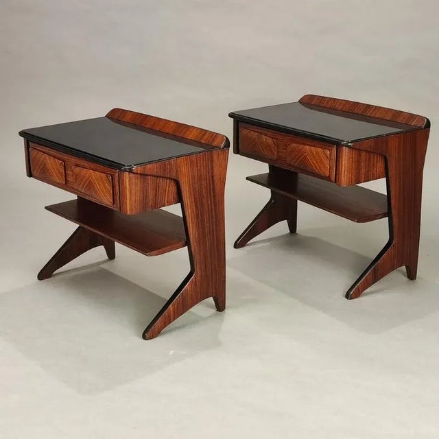 Pair of bedside tables with drawer and shelf by Vittorio Dassi, 1950s design. Mahogany veneer structure, black glass top,...