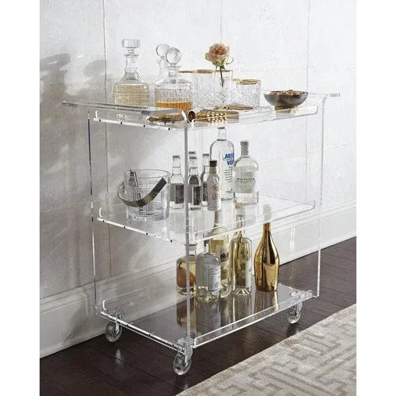 - Acrylic bar cart. - Cut-out, waterfall handles. - Three shelves; 10.25" between shelves. - 34"W x 18"D x 32"H. - Boxed...