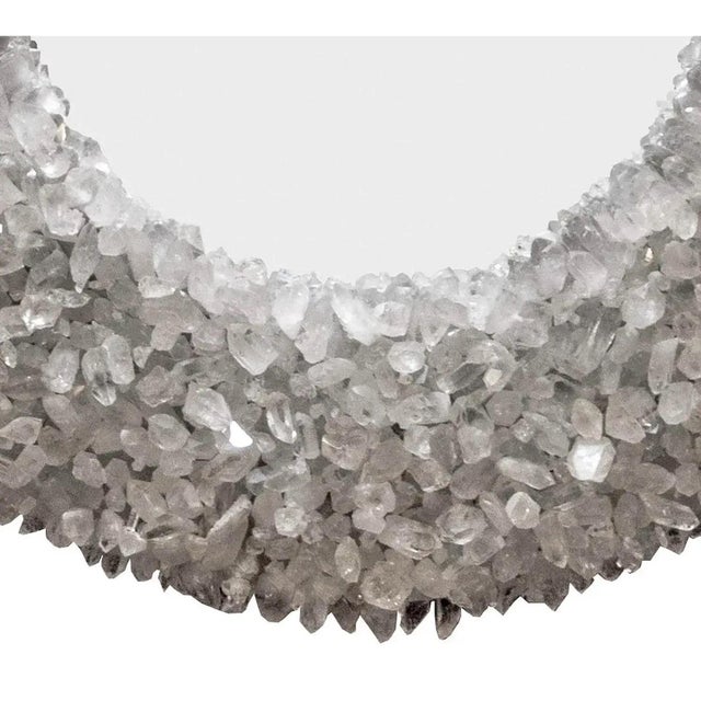 Hand-carved wood frame with a painted silver finish, dressed with thousands of Rough Quartz Crystals. 18" diameter with a...