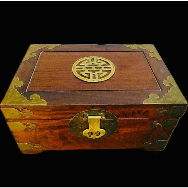 Beautiful Chinese chinoiserie jewelry box made in Hong Kong. Made of rosewood and brass hardware. Inside finished with red...