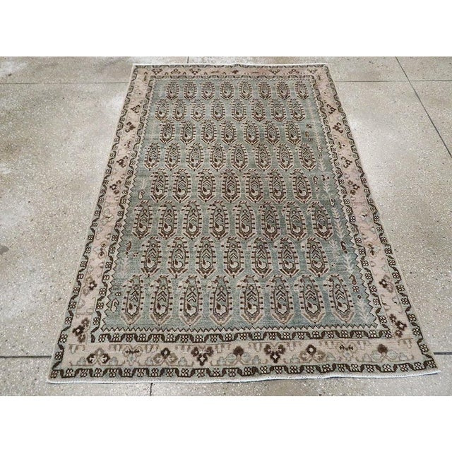 This mid-20th-century Persian Malayer accent rug presents a finely ordered allover composition across a muted blue field....