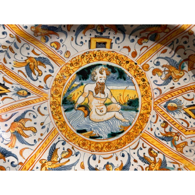 Beautiful Deruta ceramic tray from the calligraphic period (circa 1640-50), decorated with fine grotesques with masks and...