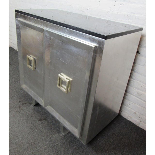 Painted cabinet with black marble top. Two door cabinet with large handles. Location: Brooklyn NY.