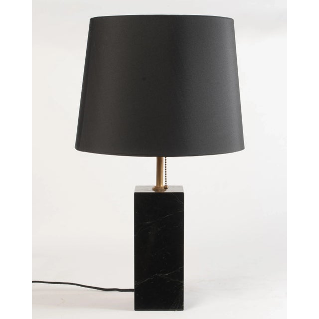 A wonderful petite marble table lamp after T.H. Robsjohn Gibbings for Hansen, New York with a well chosen piece of black...