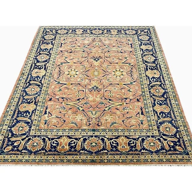 ACTUAL SIZE: 9’0″ x 11’3″ PRIMARY COLOR: Rust / Navy AGE: New ORIGIN: Pakistan MATERIALS: Wool FOUNDATION: Cotton...