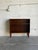 This compact rosewood bookcase pairs a clean rectangular case with one open shelf and two display levels. Four tapered...