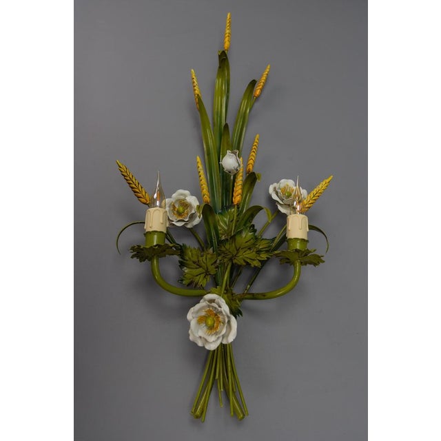 Italian toleware white poppy and wheat green floral bouquet two-light sconce from circa the 1960s. A decorative Italian...