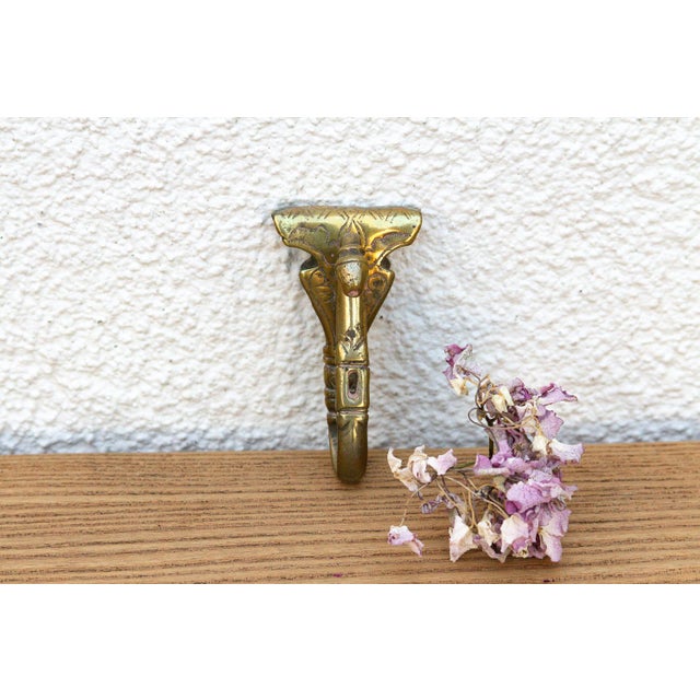 A robust utilitarian antiquity featuring a detailed geometric stem and a stylized architectural bud finial, carrying a...