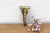 A robust utilitarian antiquity featuring a detailed geometric stem and a stylized architectural bud finial, carrying a...