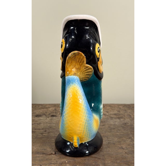This 1950s Royal Winton gurgling jug is molded in the form of a fish with its mouth open and tail curved to create a...