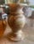 This is a decorative vase carved from natural banded stone, commonly referred to in the trade as onyx marble. It features...