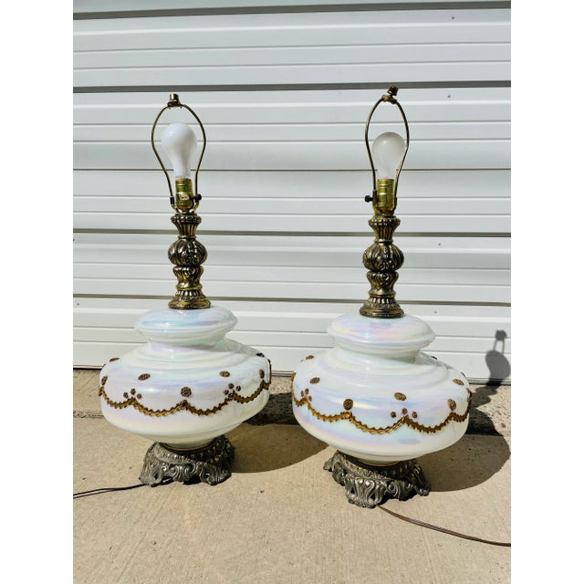 Fantastic pair of vintage 1970s iridescent white glass table lamps. Beautiful white orb middle set between a metal base...