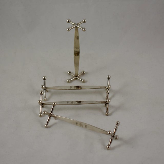 A Set Of Four Austrian Sterling Silver Knife Rests, With Traditional Cast Jack-Style Ends, Circa Mid 19Th Century. The...