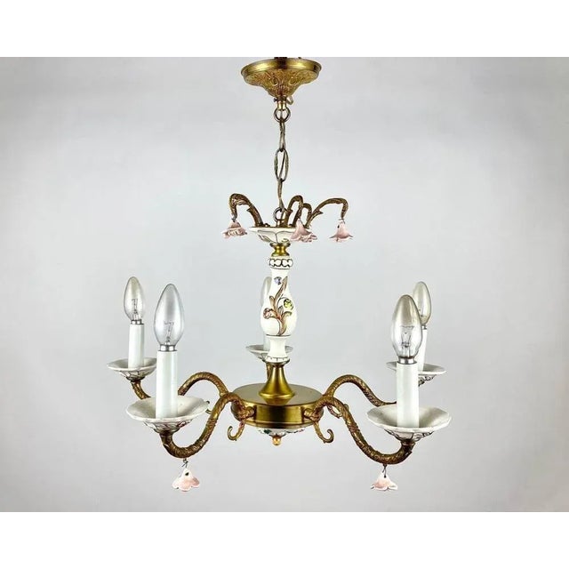 Rare vintage chandelier with 5 arms and a pair of wall sconces. Made of brass and art porcelain. Made in italy. Its design...