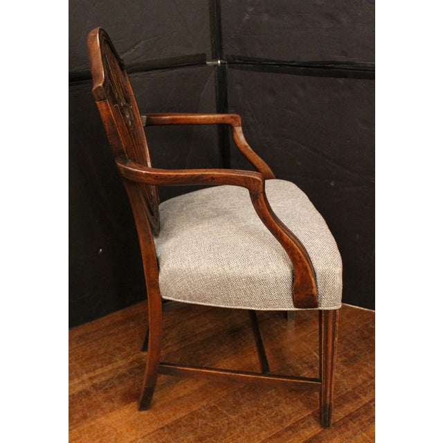 Circa 1790 Hepplewhite design shield back arm chair, English. A fine example from a country house (estate). Carved...