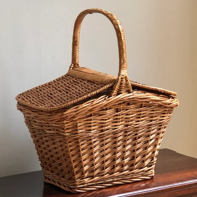 A charming mid-century wicker picnic basket with a peaked lid that opens on both sides. This basket features an intricate...