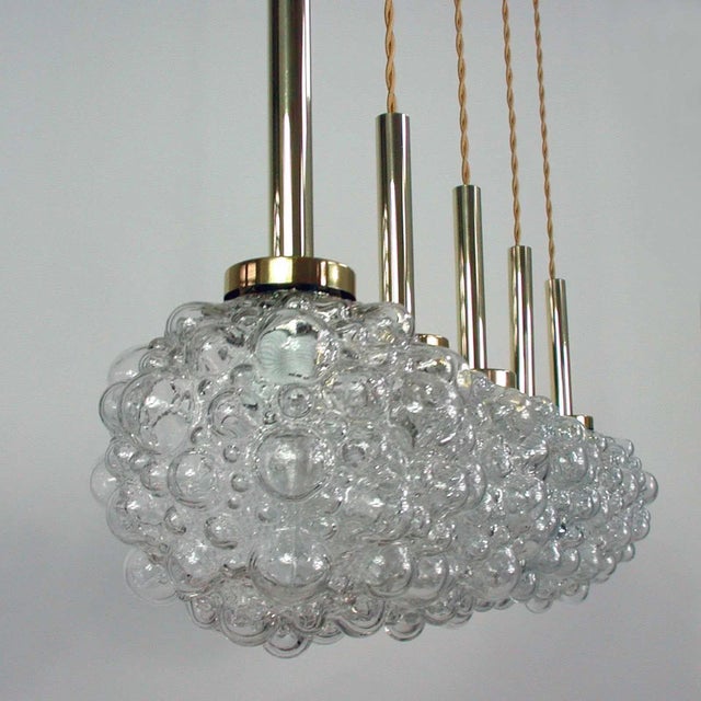 This Space Age pendant lamp was designed and manufactured in Germany in the 1960s. It is made of clear bubble glass and...