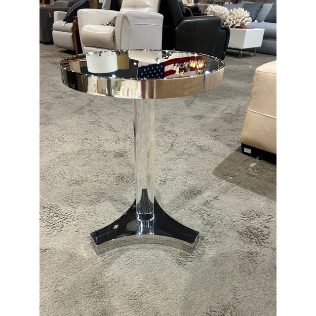 Add a touch of modern glam to your living space with this Lexington mirrored accent table, a stylish blend of sleek design...