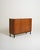 Oak cabinet with sliding roller door, adjustable shelves, and black lacquered base. Scandinavian design, 1960s. The...