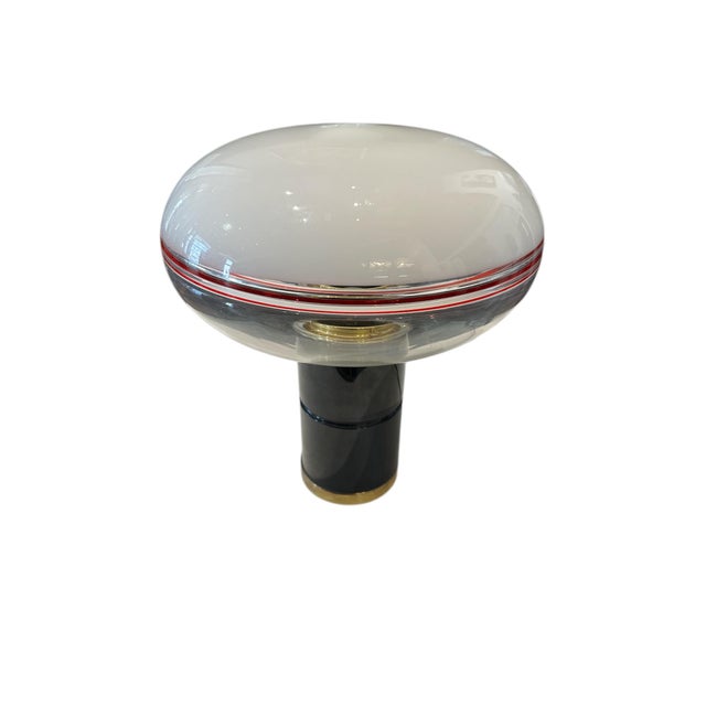 Elegant table lamp made in Italy in the 1970s, crafted from Murano glass. The large, transparent diffuser features a...