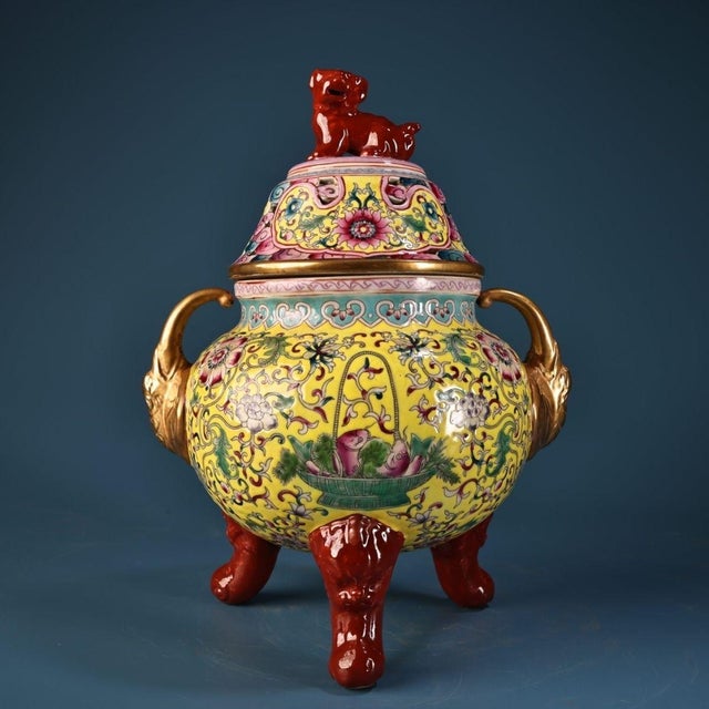 This is a striking and ornately decorated porcelain censer (incense burner), featuring a vibrant yellow ground and...