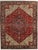 Vintage hand-knotted Persian Heriz wool rug with a red field centered by a large geometric medallion in blue, ivory, and...