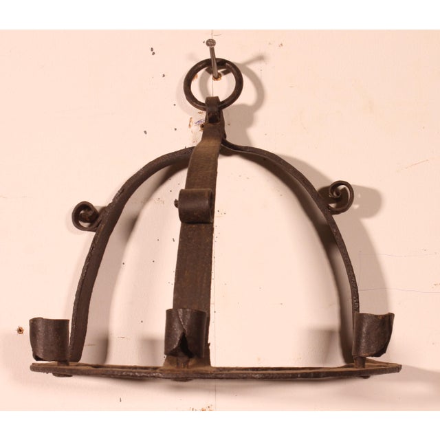Exquisite pair of wrought iron wall sconces crafted with period elements. Superb work with great character. In perfect...