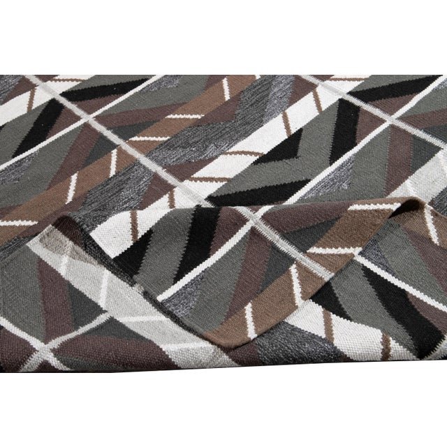 Beautiful contemporary Swedish style rug with a gray field with purple, brown, and green accents with an all-over...