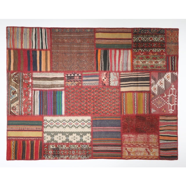 This striking patchwork kilim is a one of a kind composition crafted from handwoven vintage fragments of tribal Turkish...
