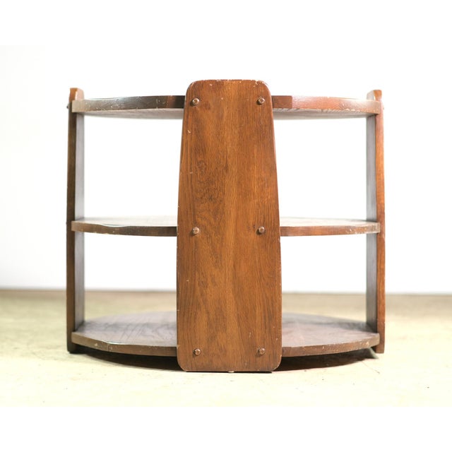 Art Deco petite round oak table, only two feet wide and high. Three shelves with four gently curved waterfall style...