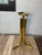 A striking Postmodern plant stand or display pedestal crafted in polished brass, featuring an architectural arrangement of...