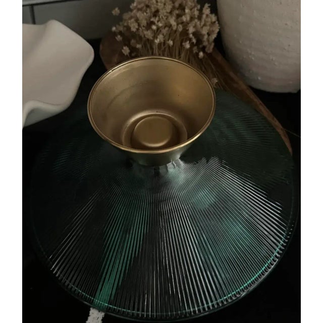 A stunning mid-century compote bowl featuring a flared smoked-glass top with fine radiating rib texture, elegantly perched...