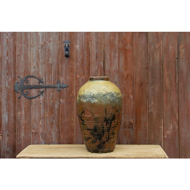 A lovely antique earthenware wine jar. This jar features its original sage green glazed finish. **Please bear in mind that...